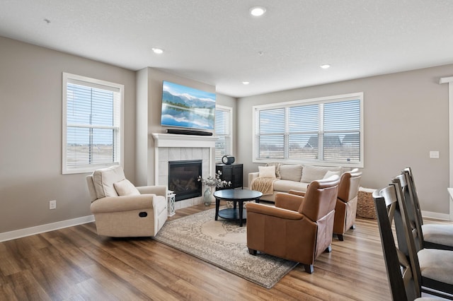 19000 72nd Pl N, Maple Grove, MN 55311 - living room featuring wood finished floors, a fireplace, baseboards, and recessed lighting