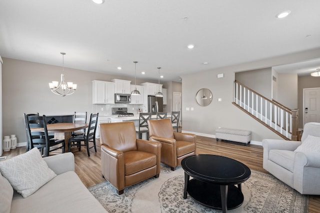 19000 72nd Pl N, Maple Grove, MN 55311 - living room with light wood finished floors, stairway, a chandelier, baseboards, and recessed lighting