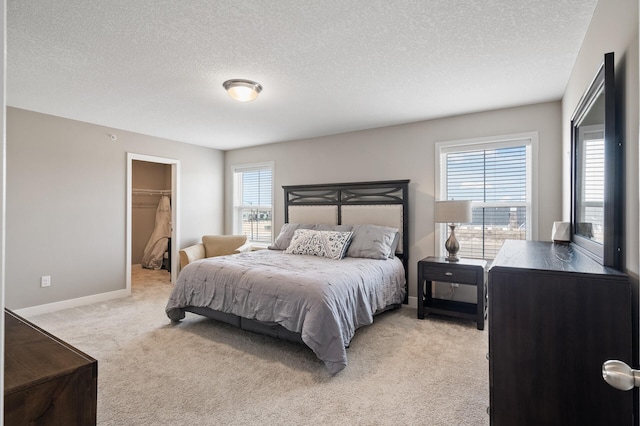 19000 72nd Pl N, Maple Grove, MN 55311 - bedroom featuring light carpet, multiple windows, a textured ceiling, baseboards, and a spacious closet