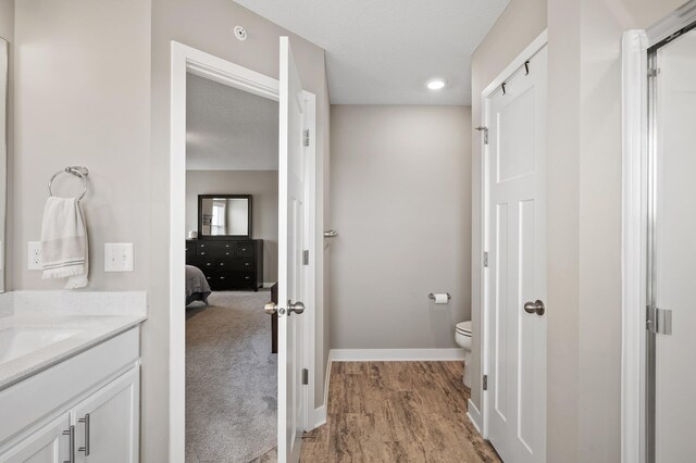 19000 72nd Pl N, Maple Grove, MN 55311 - ensuite bathroom featuring toilet, baseboards, and vanity