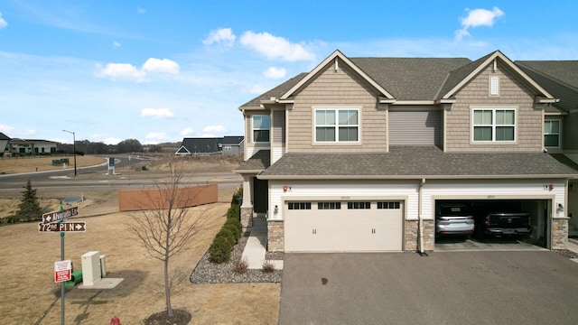 19000 72nd Pl N, Maple Grove, MN 55311 - view of front facade featuring an attached garage, a shingled roof, driveway, and stone siding