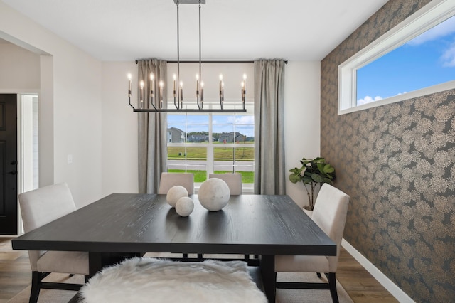 dining area featuring wood finished floors and a chandelier