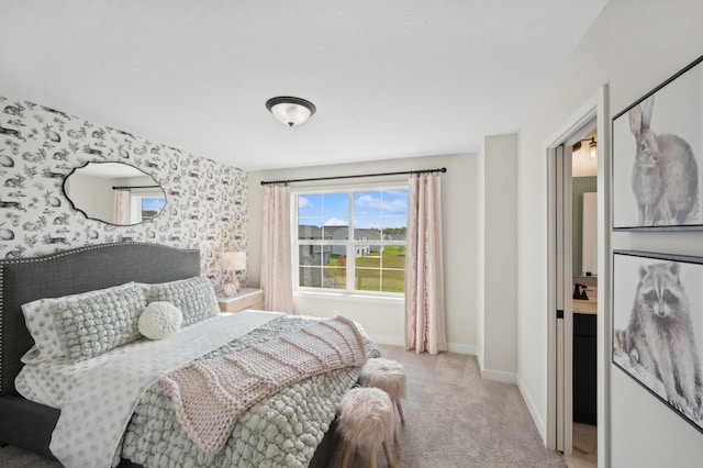 carpeted bedroom featuring baseboards and wallpapered walls