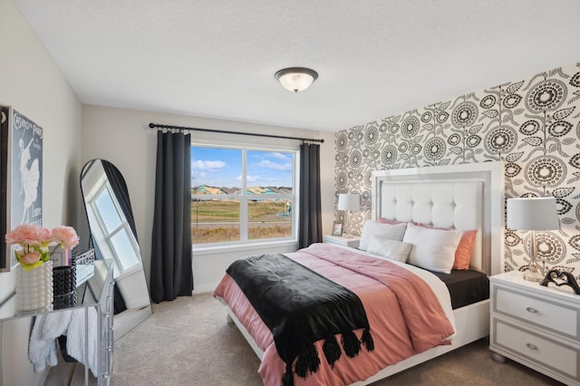 carpeted bedroom featuring multiple windows and a textured ceiling