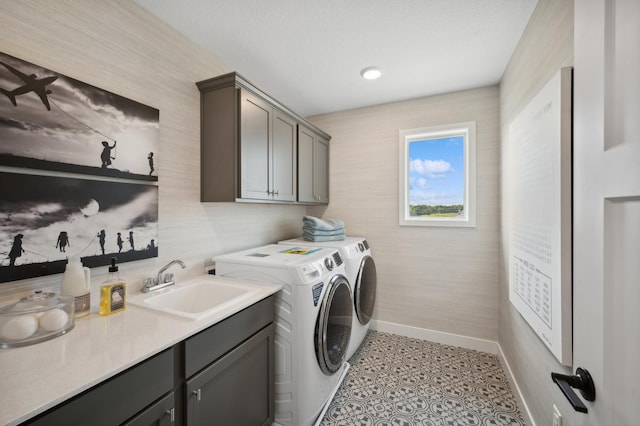 washroom with cabinet space, washer and clothes dryer, and baseboards