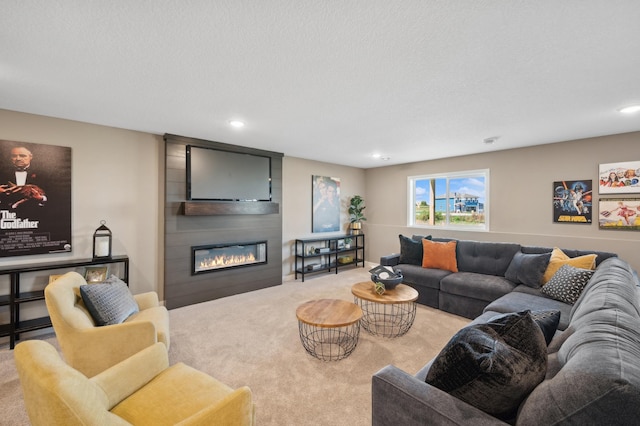 carpeted living room featuring a fireplace, recessed lighting, and a textured ceiling