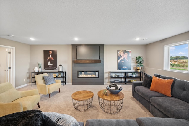 living room with recessed lighting, carpet flooring, a fireplace, a textured ceiling, and baseboards