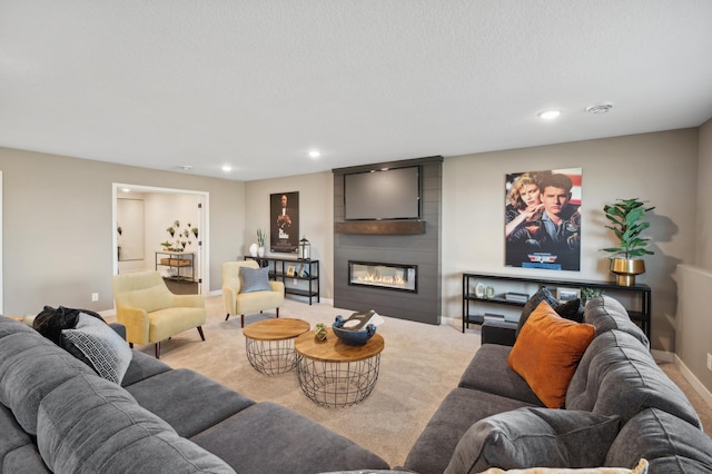 living room with recessed lighting, carpet floors, baseboards, and a large fireplace