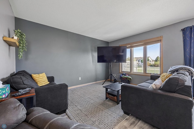 living area with baseboards and wood finished floors