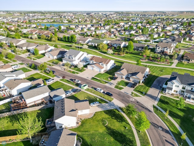 aerial view of property and surrounding area with nearby suburban area and a nearby body of water
