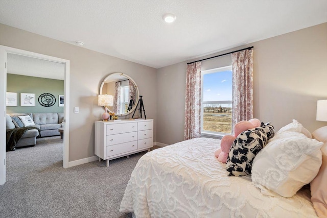 carpeted bedroom featuring baseboards
