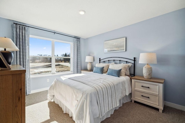 bedroom featuring carpet and baseboards