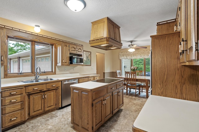 32355 Nottingham Ct, Chisago Lake Twp, MN 55045 - kitchen with appliances with stainless steel finishes, a sink, a center island, ceiling fan, and brown cabinetry