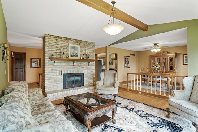 32355 Nottingham Ct, Chisago Lake Twp, MN 55045 - living area with wood finished floors, a brick fireplace, ceiling fan, and baseboards