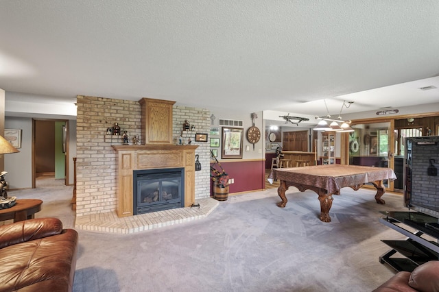 32355 Nottingham Ct, Chisago Lake Twp, MN 55045 - rec room with a brick fireplace, billiards table, a textured ceiling, and carpet flooring