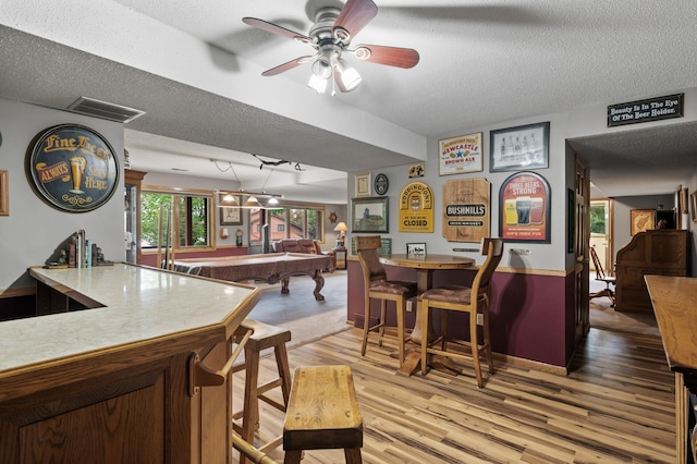 32355 Nottingham Ct, Chisago Lake Twp, MN 55045 - dining space featuring billiards, a textured ceiling, wood finished floors, bar, and ceiling fan