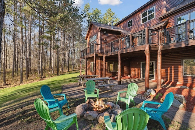 12640 Fawn Lake Rd, Crosslake, MN 56442 - rear view of property with an outdoor fire pit, a deck, faux log siding, and a yard