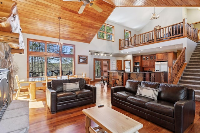 12640 Fawn Lake Rd, Crosslake, MN 56442 - living room with a chandelier, high vaulted ceiling, stairway, wood finished floors, and wooden ceiling