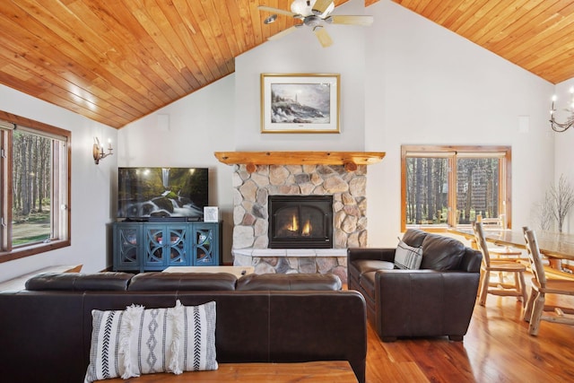 12640 Fawn Lake Rd, Crosslake, MN 56442 - living room featuring wood finished floors, wood ceiling, a ceiling fan, a stone fireplace, and high vaulted ceiling