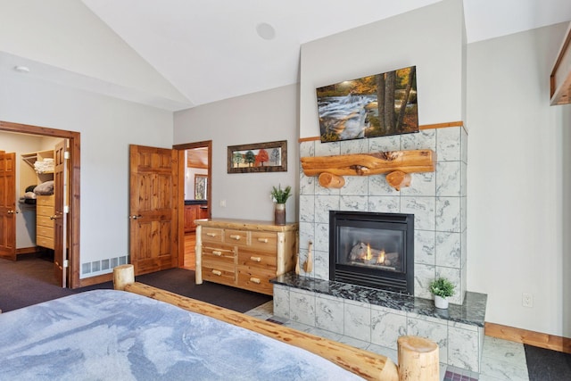 12640 Fawn Lake Rd, Crosslake, MN 56442 - carpeted bedroom featuring vaulted ceiling, a fireplace, a spacious closet, and baseboards