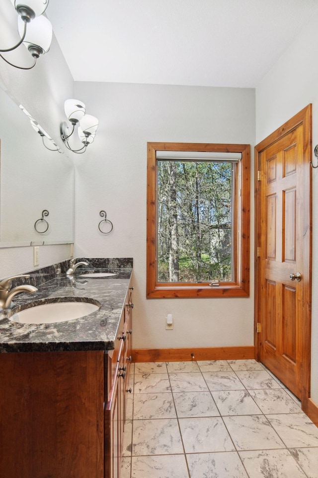 12640 Fawn Lake Rd, Crosslake, MN 56442 - bathroom with baseboards and double vanity