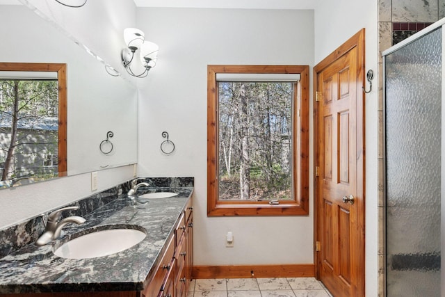 12640 Fawn Lake Rd, Crosslake, MN 56442 - bathroom with baseboards, a shower stall, double vanity, and marble finish floors