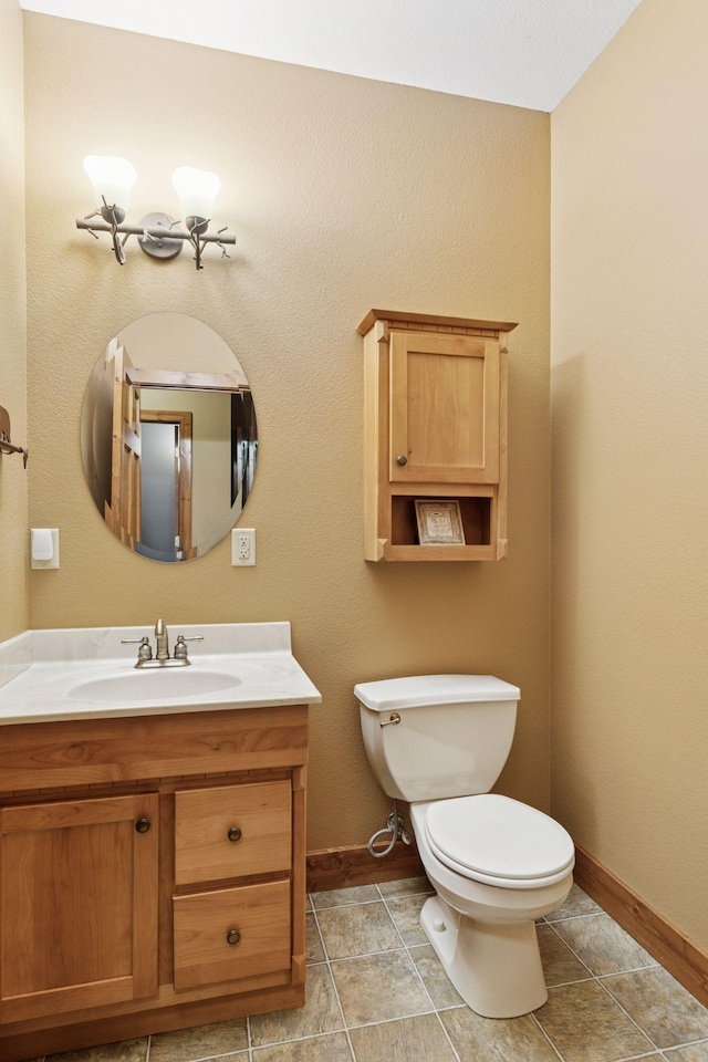 12640 Fawn Lake Rd, Crosslake, MN 56442 - half bathroom with toilet, baseboards, vanity, and tile patterned flooring