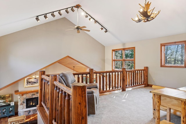 12640 Fawn Lake Rd, Crosslake, MN 56442 - bonus room featuring lofted ceiling, ceiling fan, carpet floors, a stone fireplace, and a chandelier