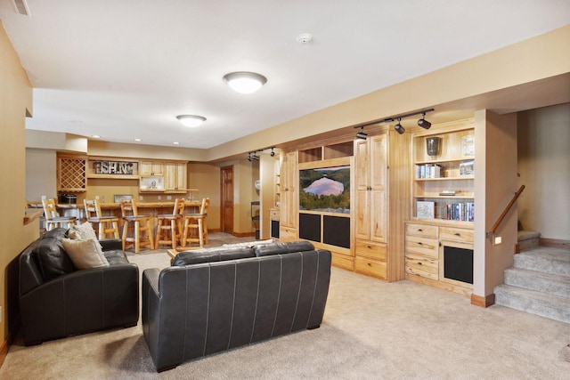 12640 Fawn Lake Rd, Crosslake, MN 56442 - living room with light colored carpet, bar area, stairs, and baseboards