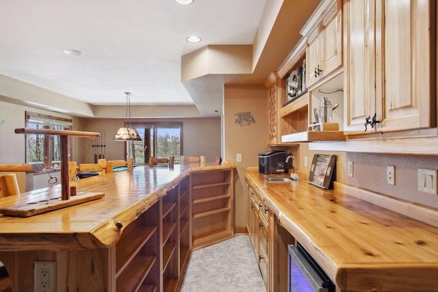 12640 Fawn Lake Rd, Crosslake, MN 56442 - kitchen featuring open shelves, butcher block countertops, a sink, a peninsula, and recessed lighting