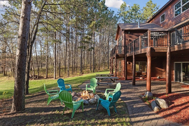 12640 Fawn Lake Rd, Crosslake, MN 56442 - view of jungle gym featuring an outdoor fire pit, a wooden deck, and a yard