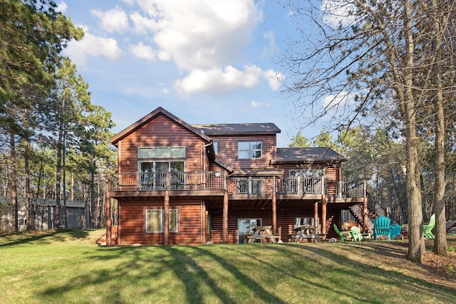 12640 Fawn Lake Rd, Crosslake, MN 56442 - back of house with stairway, a lawn, and a wooden deck
