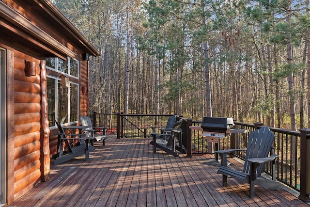 12640 Fawn Lake Rd, Crosslake, MN 56442 - wooden terrace with a grill and a wooded view