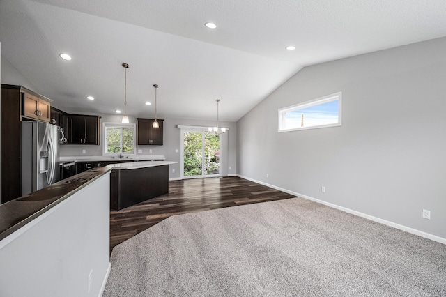 kitchen featuring stainless steel fridge, a chandelier, a sink, baseboards, and dark wood finished floors