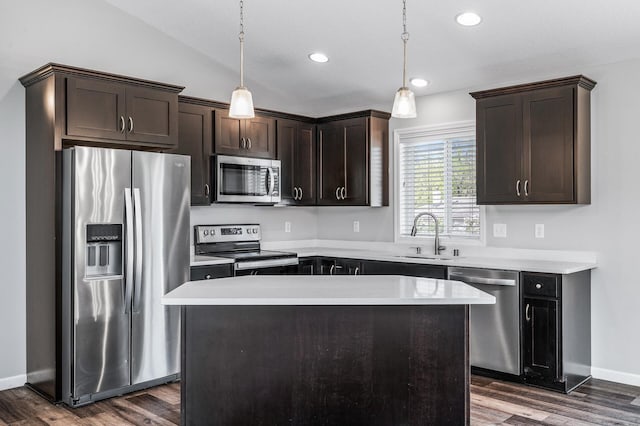 kitchen with stainless steel appliances, a sink, dark brown cabinetry, dark wood-type flooring, and lofted ceiling