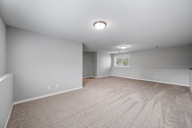 unfurnished room featuring carpet floors and baseboards