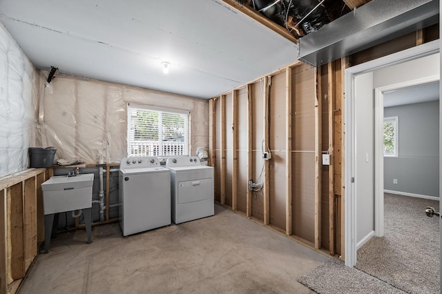 basement featuring washer and dryer, healthy amount of natural light, and a sink