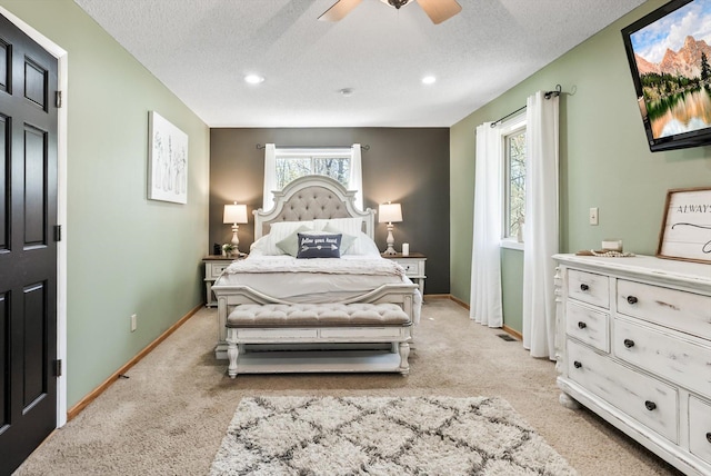 bedroom with light carpet, baseboards, a textured ceiling, recessed lighting, and a ceiling fan