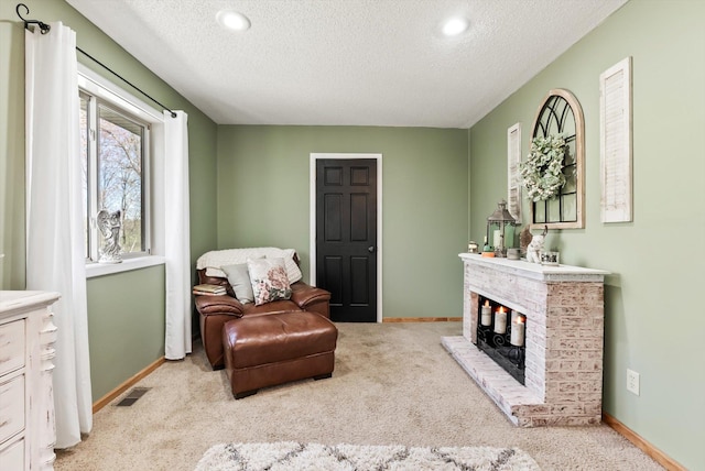 living area featuring a textured ceiling, baseboards, carpet flooring, and recessed lighting