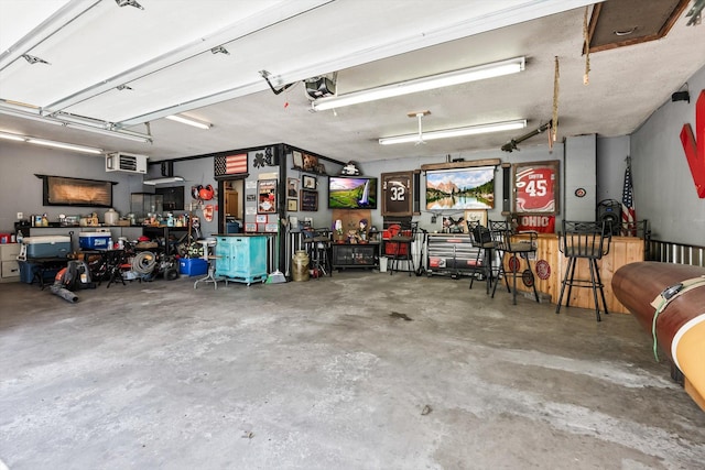 garage with a workshop area and a garage door opener