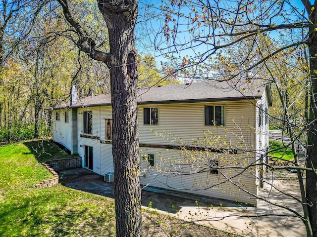 view of home's exterior with a patio and a yard
