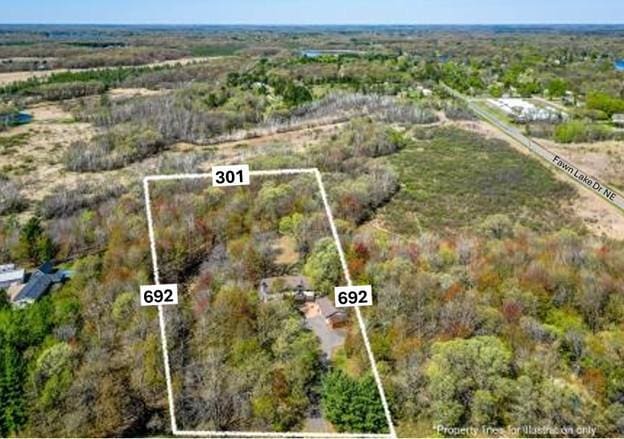 aerial overview of property's location featuring property parcel outlined and a heavily wooded area