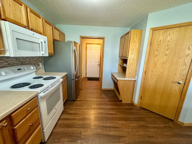 kitchen featuring white appliances, dark wood-style flooring, backsplash, light countertops, and a textured ceiling