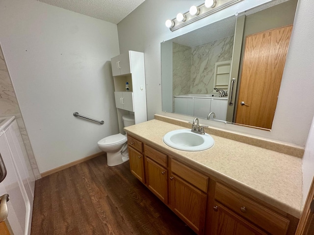 full bath with wood finished floors, a textured ceiling, toilet, and vanity