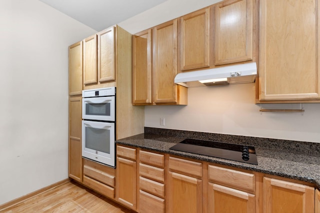 3709 Grand Way Unit 315, Saint Louis Park, MN 55416 - kitchen with under cabinet range hood, black electric cooktop, double oven, light wood-style flooring, and light brown cabinetry