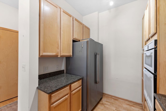 3709 Grand Way Unit 315, Saint Louis Park, MN 55416 - kitchen with double oven, high end fridge, light wood finished floors, light brown cabinetry, and dark stone countertops