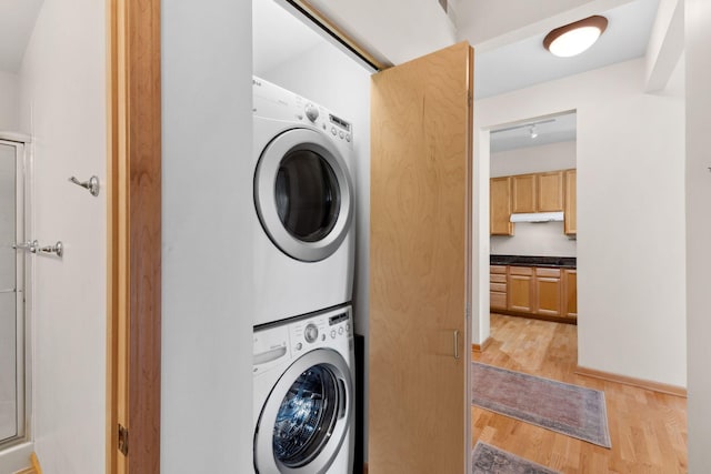 3709 Grand Way Unit 315, Saint Louis Park, MN 55416 - laundry room featuring stacked washer / drying machine and light wood-type flooring