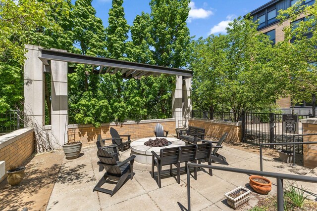 3709 Grand Way Unit 315, Saint Louis Park, MN 55416 - view of patio / terrace featuring an outdoor fire pit and fence