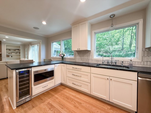 14700 Minnehaha Pl, Minnetonka, MN 55391 - kitchen featuring wine cooler, a sink, stainless steel appliances, light wood finished floors, and ornamental molding