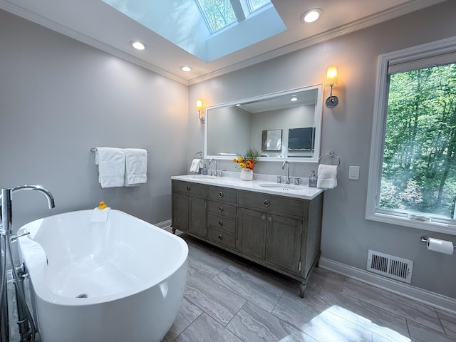 14700 Minnehaha Pl, Minnetonka, MN 55391 - bathroom with a skylight, baseboards, ornamental molding, double vanity, and a freestanding bath